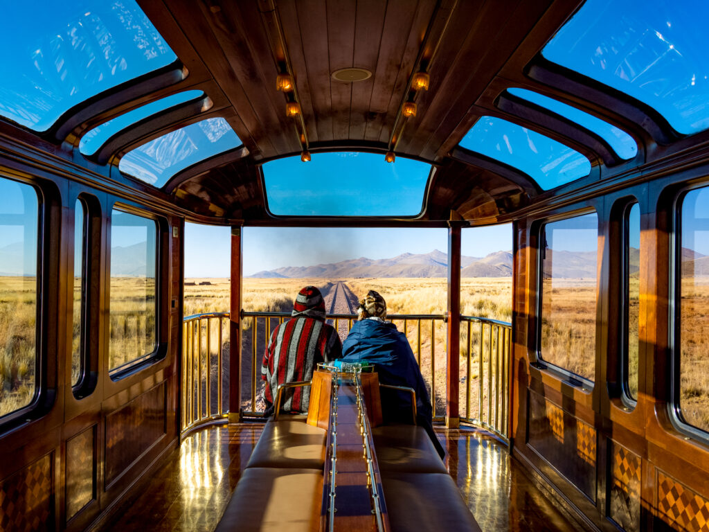 Antiplano, Peru – May 23 2018: Enjoying the observation deck of the PeruRail Titicaca Train, crossing the antiplano on the journey from Puno to Cusco, Peru